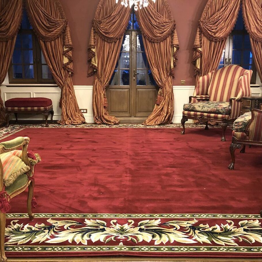 Укладка и фиксация ковра в большой комнате с камином